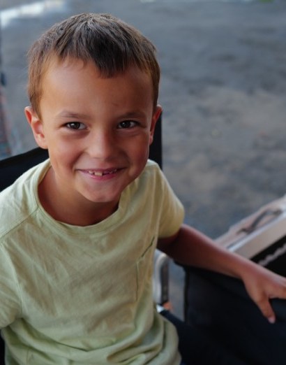 Owen, the maker behind Owen's Print Shop, smiling in a director's chair
